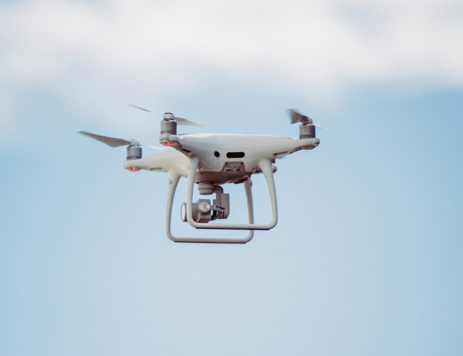 Quadcopter drone in flight against an open sky